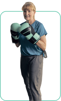 A woman in boxing gloves with a VYALEV pump carry case around her hip.